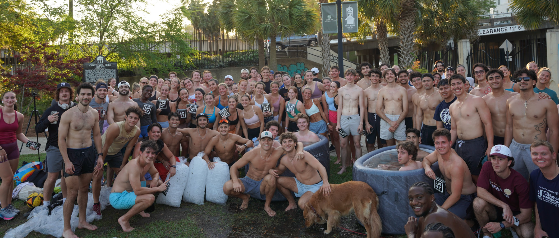 Large group of Peak Pulse Run Club members enjoying post-run ice baths, electrolytes, and good company